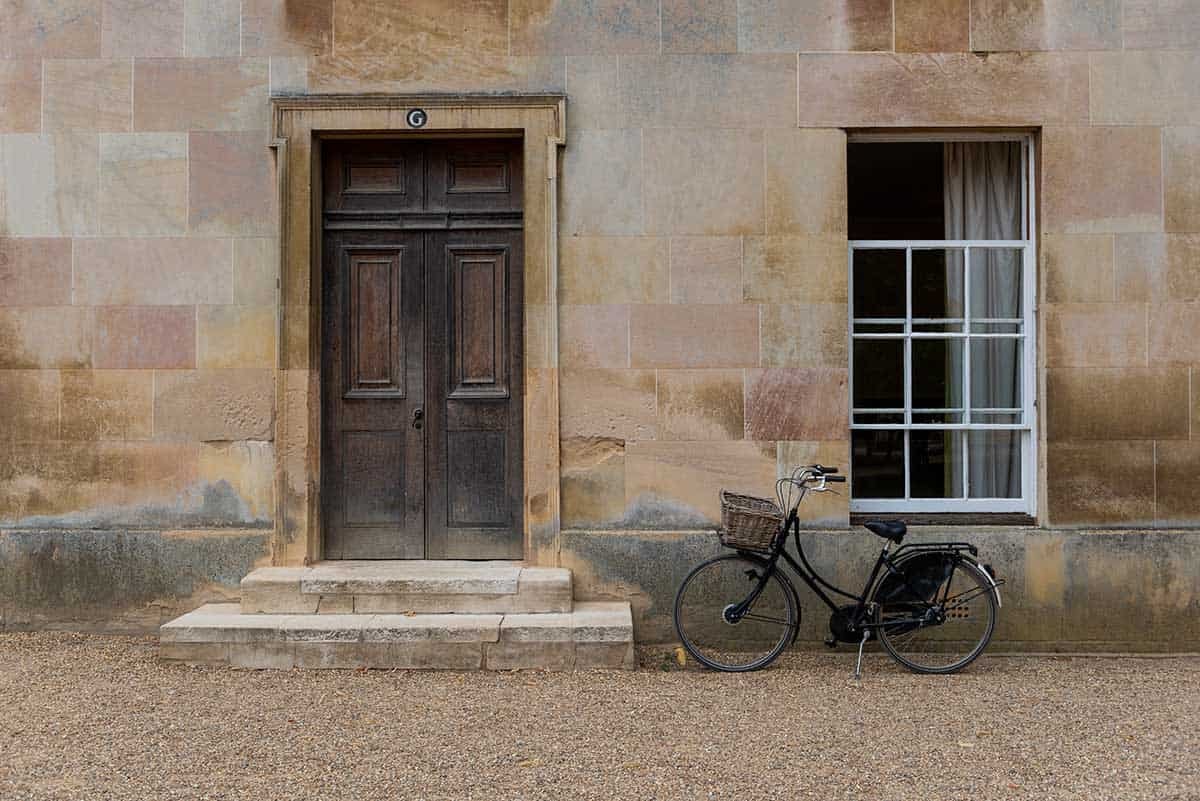 A bicycle beside a stone doorway at Downing College, Cambridge