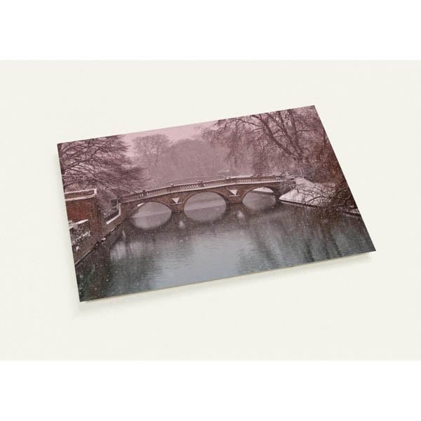 Clare Bridge at dawn in the snow beneath a pink sky